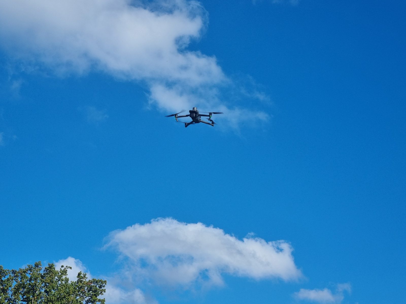Multispectral survey drone in flight against a blue sky
